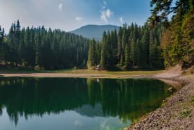 Breathtaking view of a lake surrounded by high Carpathian mountains